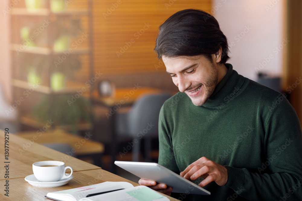 Successful businessman planning his day at cafe, using digital tablet, taking notes, free space