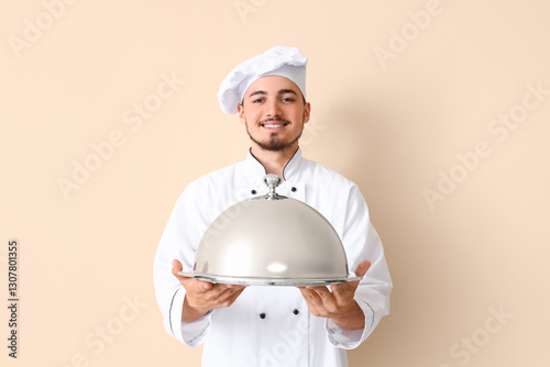 Male chef with cloche on be...