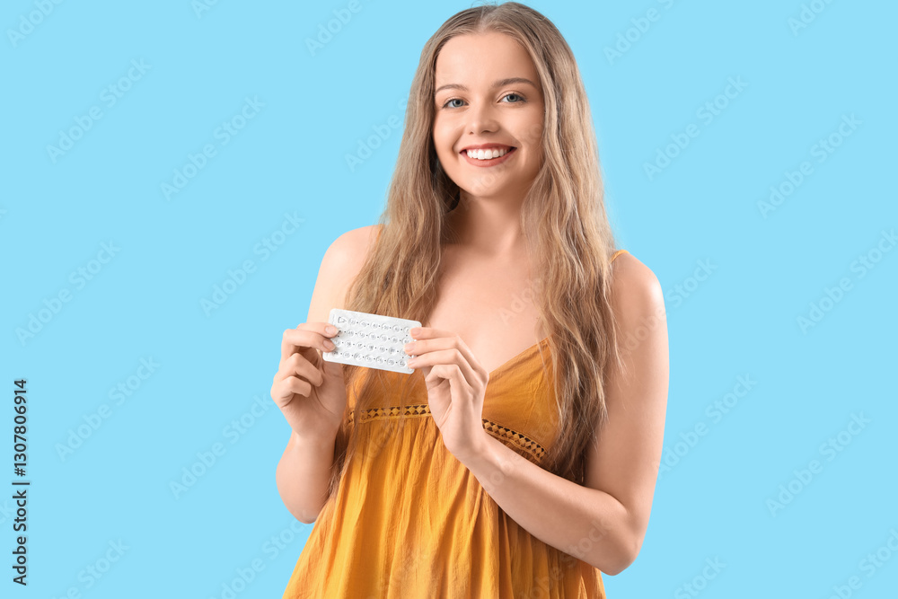 Young woman with contraceptive pills on blue background Young woman with contraceptive pills on blue background