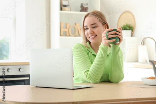 Young woman with cup of hot...
