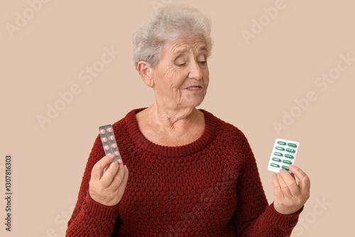 Senior woman with pills on ...