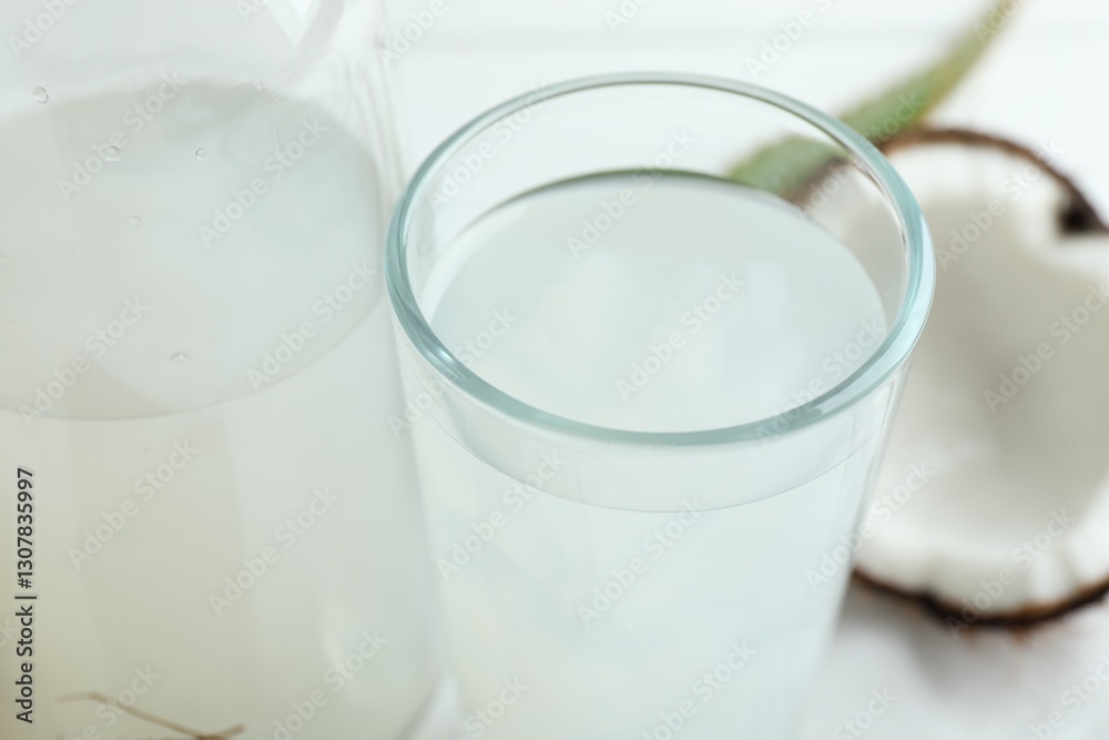 Refreshing drink with coconut and aloe on white table, closeup Refreshing drink with coconut and aloe on white table, closeup