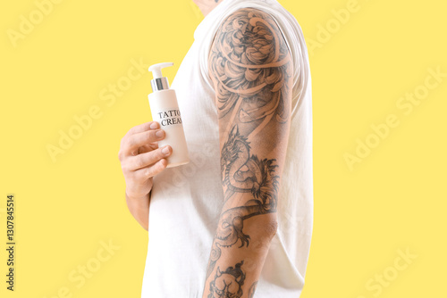 Young man with bottle of ta...