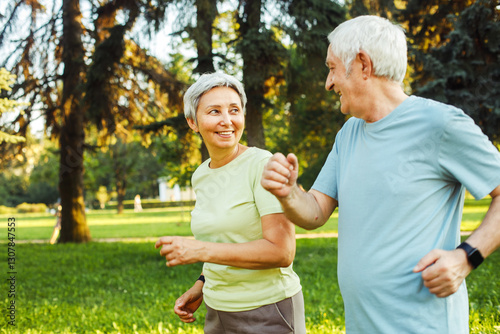 Smiling senior couple jogging in the park. Close up picture.
