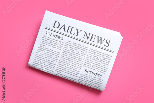 Daily newspaper on pink background