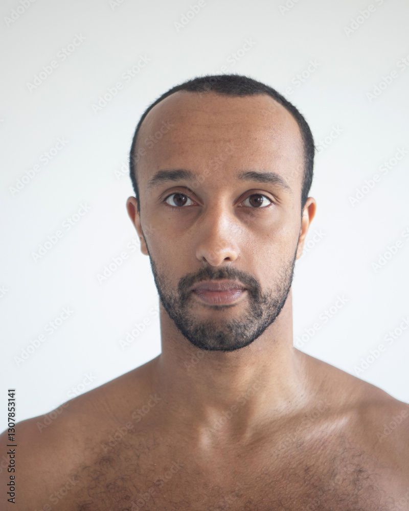 Fototapeta premium Dark-skinned man, head close-up over white background.