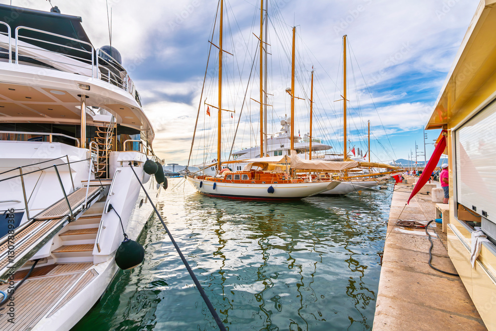 Sailboats and luxury yachts in the old port marina at the Mediterranean city of Saint-Tropez, France, on the French Riviera Cote d'Azur. Sailboats and luxury yachts in the old port marina at the Mediterranean city of Saint-Tropez, France, on the French Riviera Cote d'Azur.
