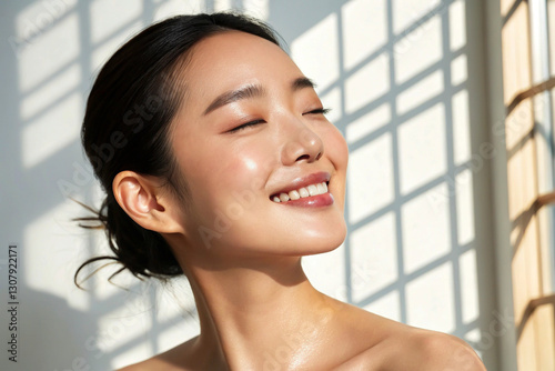 Beautiful Korean model in 20s with innocent image, mid-shot against white background, showcasing cool sensation on dewy skin while applying serum.