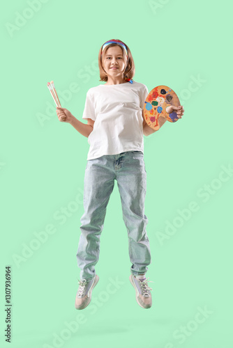 Teenage girl jumping with p...