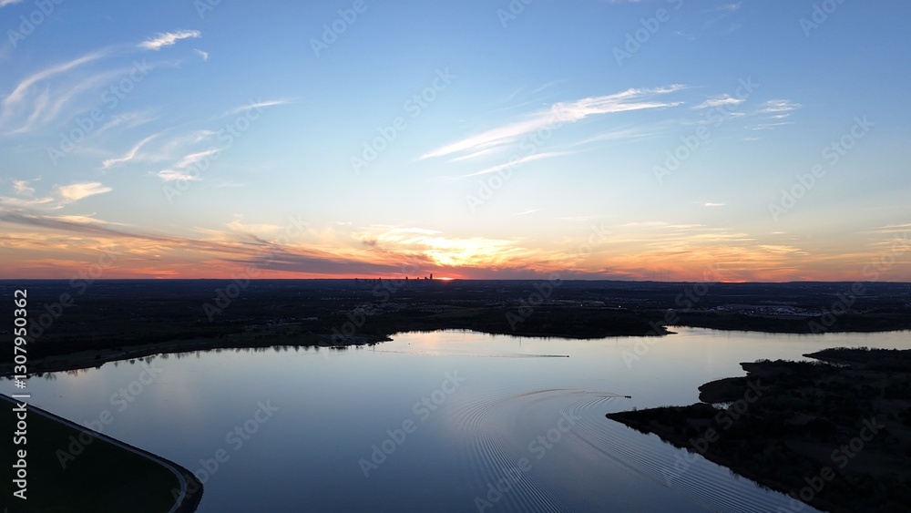 Fototapeta premium Aerial view of orange sunset over the lake