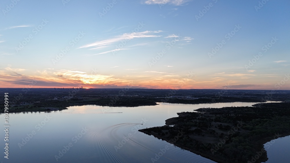 Fototapeta premium Aerial view of orange sunset over the lake