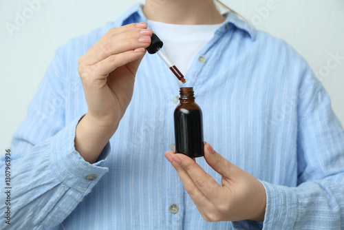 Woman with bottle and pipet...