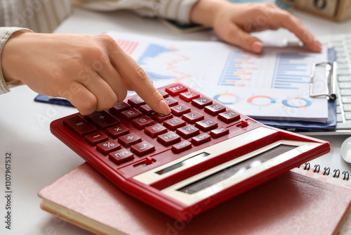 Person using a red calculat...