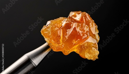 live rosin on a dab tool with a black background