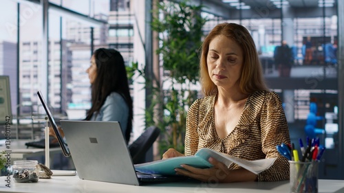 Business sales manager at work finalizes strategy planning in her office, doing report writing and answering emails. Worker collaborates on project management, uses data to drive decisions. Camera A.