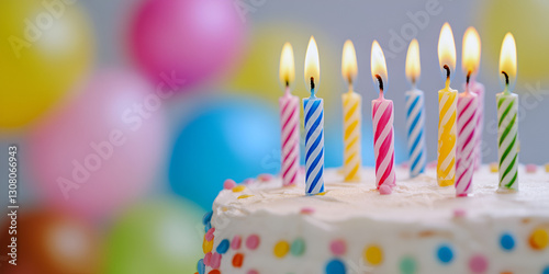 Birthday Cake with Colorful Candles and Party Balloons
