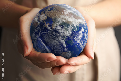 Fotografija Planet in our hands. Woman holding Earth model, closeup