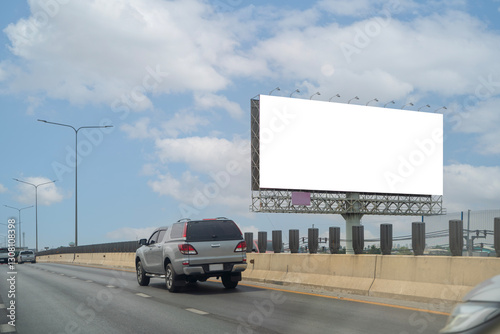 A large, blank billboard on the side of a highway. The billboard is white. It is located in a rural area.