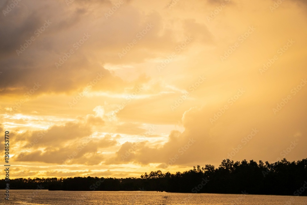 Obraz premium Dramatic Sunset Over a Tranquil River, Weston Wetland, Kota Kinabalu, Sabah, Malaysia