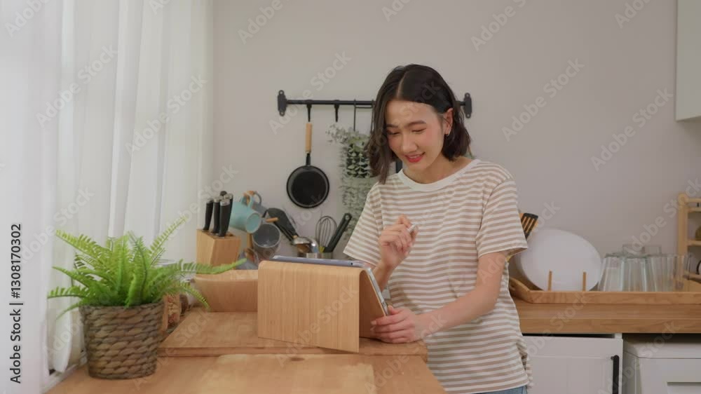 Asian young woman using digital tablet browse social media in house. Asian young woman using digital tablet browse social media in house.