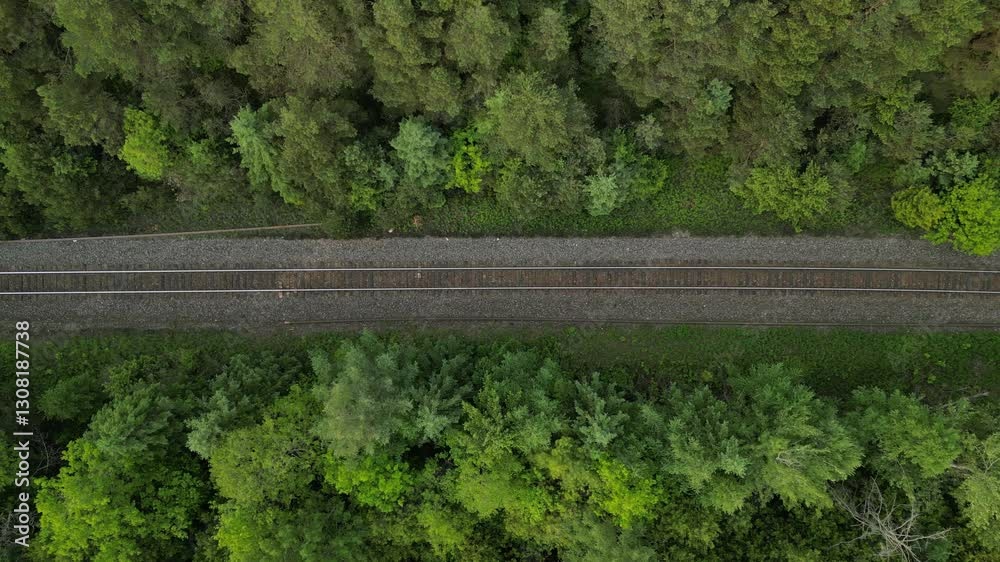 Vertical travelling view of a railway track in a forest - Vue verticale aérienne en travelling d'une voie de chemin de fer dans une forêt