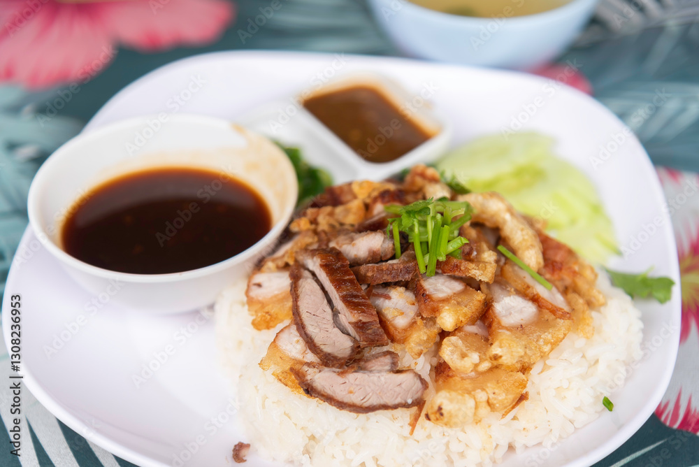 Crispy pork rice on a white plate on the dining table Crispy pork rice on a white plate on the dining table