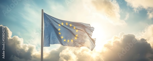 A blue flag with yellow stars flying in a bright sky