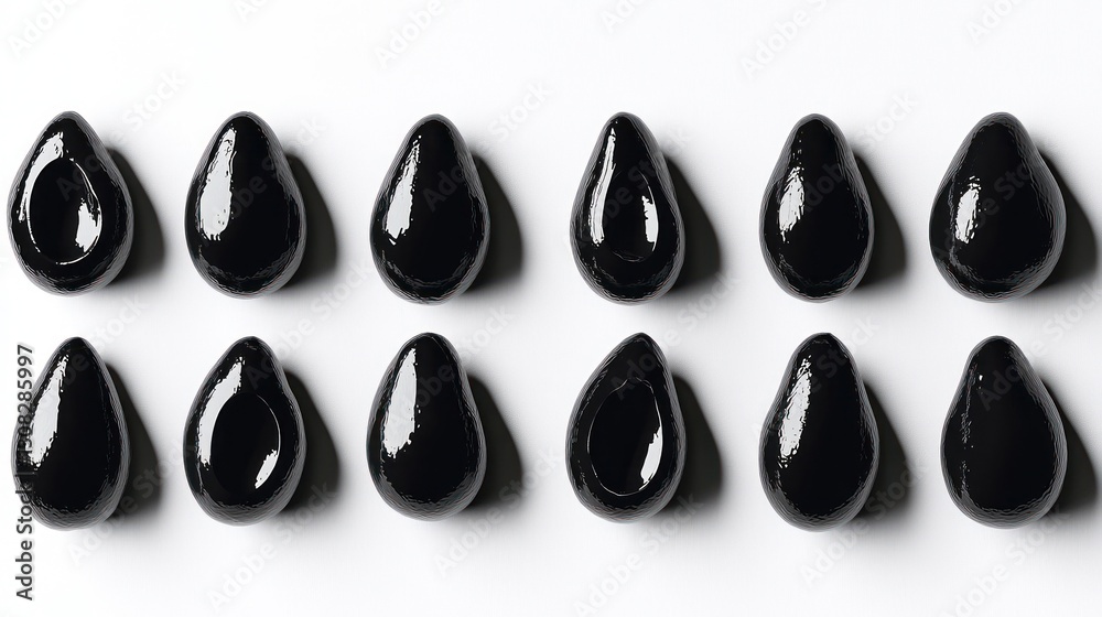 Black olives arranged in a grid, studio shot Black olives arranged in a grid, studio shot