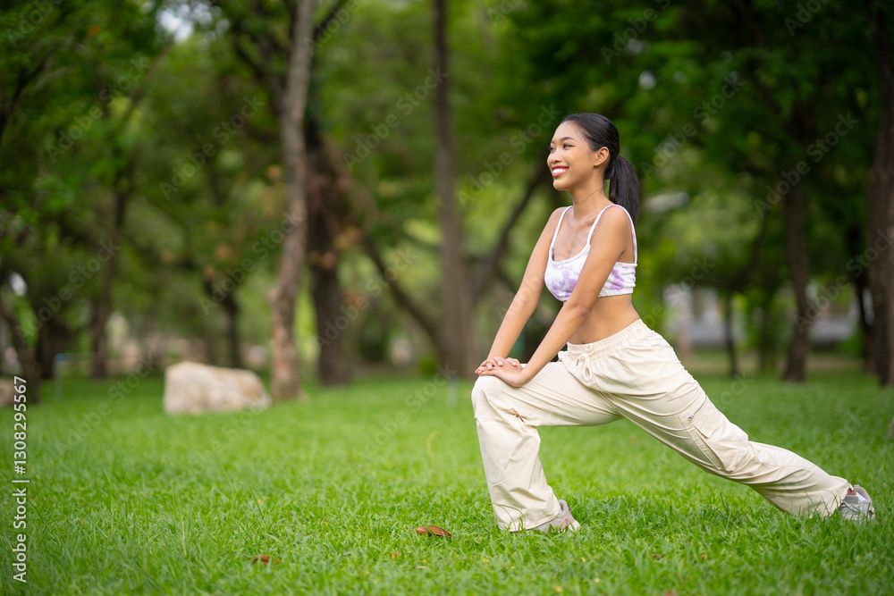 Fit sporty mindful young Asian woman meditating doing stretching exercises feeling peace of mind, mental balance standing in green nature tropical park on sunny day. Fit sporty mindful young Asian woman meditating doing stretching exercises feeling peace of mind, mental balance standing in green nature tropical park on sunny day.