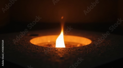 Close-up of an eternal flame burning brightly in the center of a stone monument,