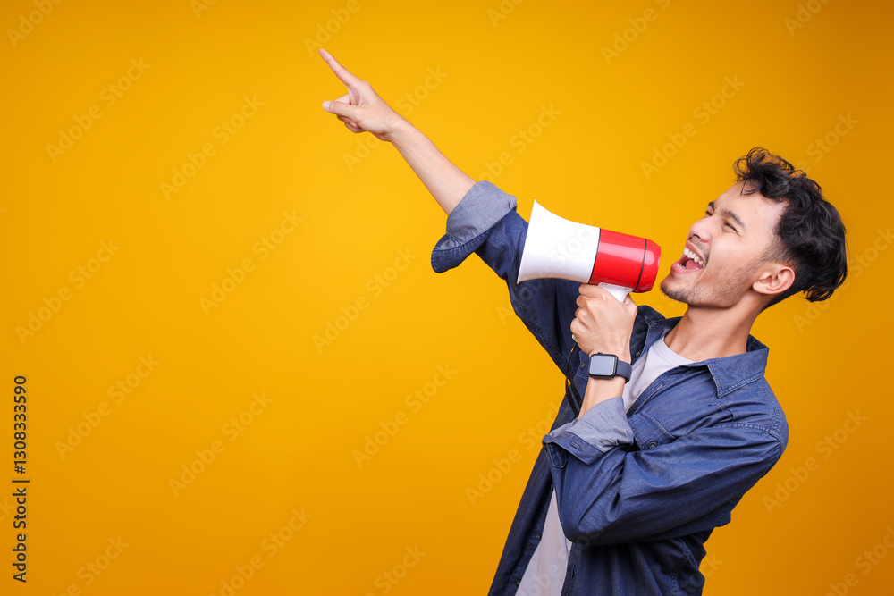 Happy Young Asian Man In Casual Style Scream In Megaphone Shout Point Index Finger Aside Happy Young Asian Man In Casual Style Scream In Megaphone Shout Point Index Finger Aside