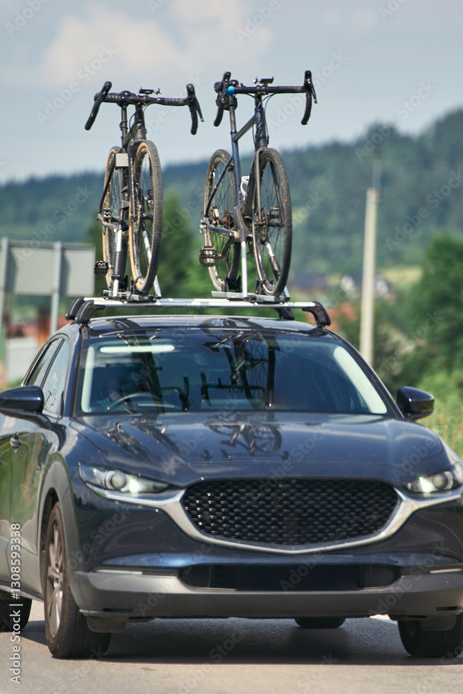 Cars driving on a road with bikes on the roof