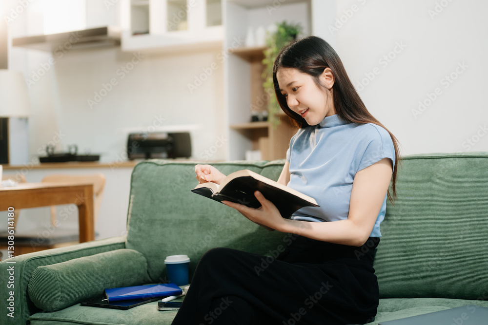 Asian woman using the smartphone and tablet on the sofa at home. Asian woman using the smartphone and tablet on the sofa at home.