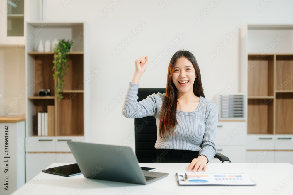 Asian Businesswoman Analyzing Finance on Tablet and Laptop at modern Office Desk Asian Businesswoman Analyzing Finance on Tablet and Laptop at modern Office Desk