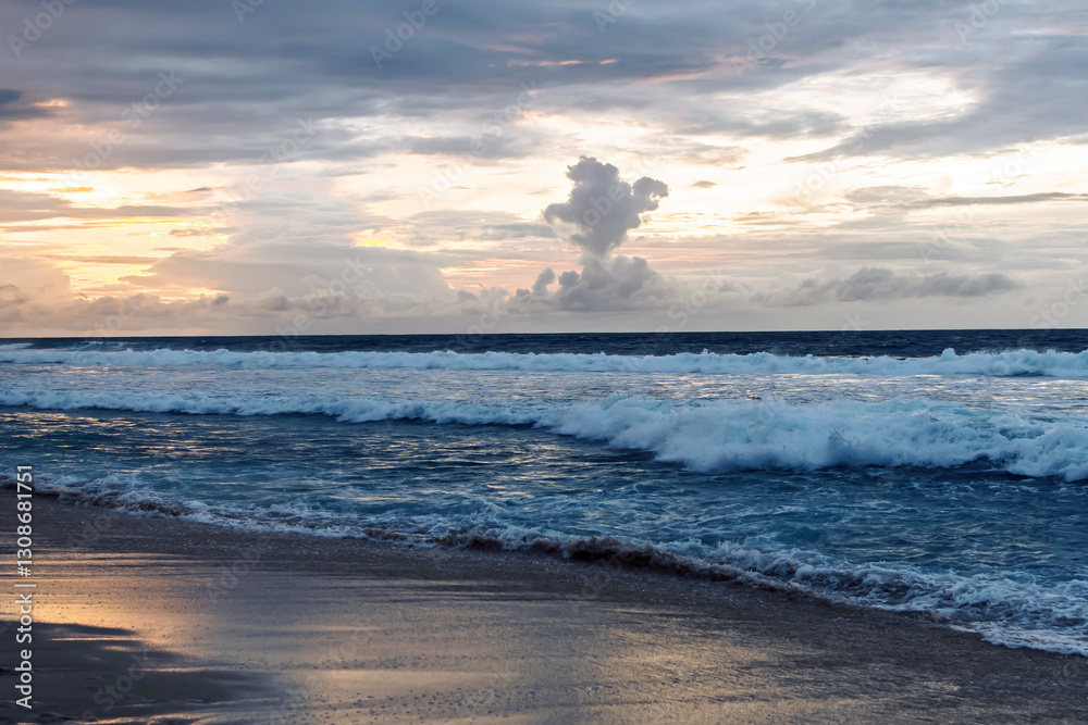 The sun sets over the ocean, casting golden hues across the waves. A dramatic cloud formation adds depth to the tranquil coastal landscape. The sun sets over the ocean, casting golden hues across the waves. A dramatic cloud formation adds depth to the tranquil coastal landscape.