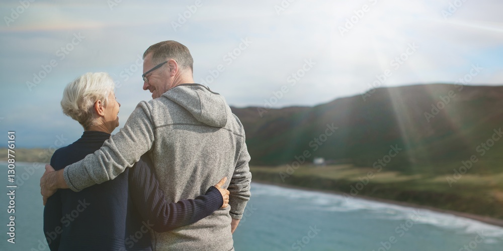 Fototapeta premium Elderly Caucasian couple, man and woman, embracing by the sea. The elderly couple enjoys the scenic view, with the man and woman sharing a loving moment by the sea. Senior couple hugging by the sea