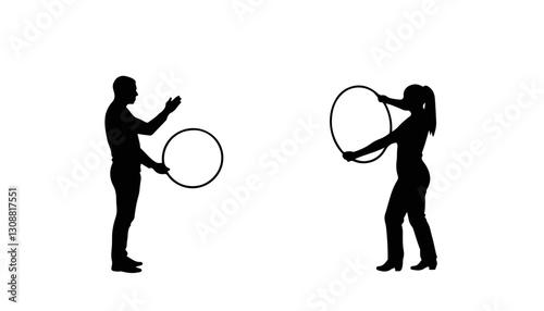 Silhouettes of man and woman playing with hula hoops