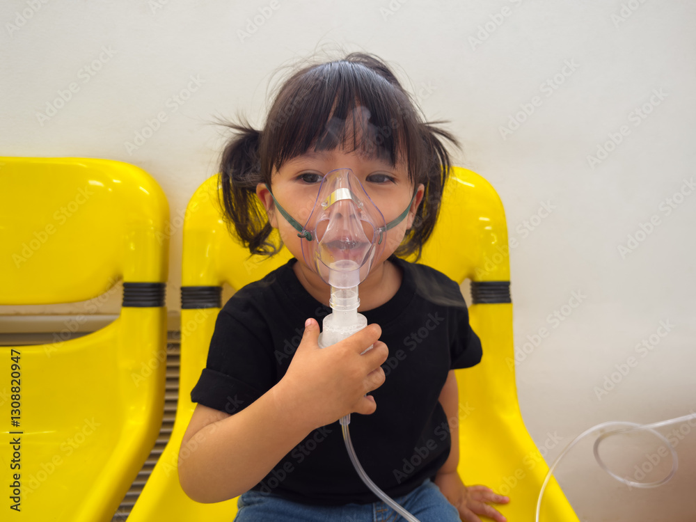 sick toddler baby girl using steam inhaler with nebulizer mask inhalation in hospital sick toddler baby girl using steam inhaler with nebulizer mask inhalation in hospital