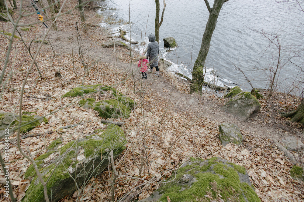 Mother and a child girl hiking in the forest Mother and a child girl hiking in the forest