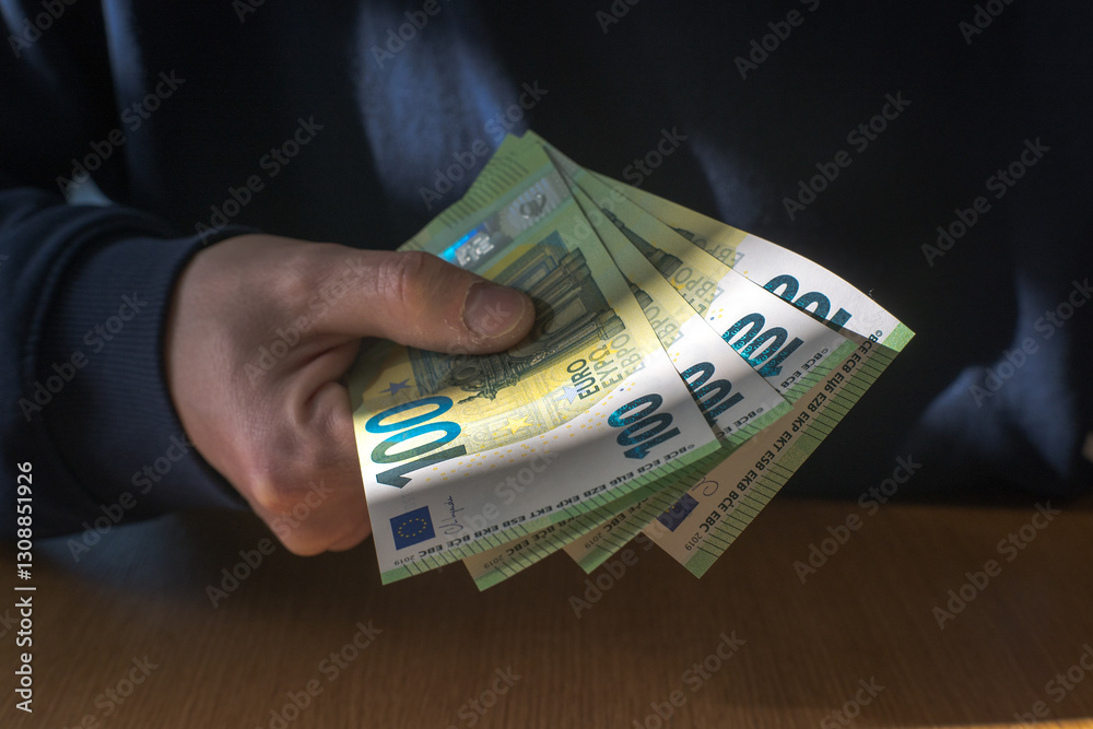 Man holding money in hand, euro currency.