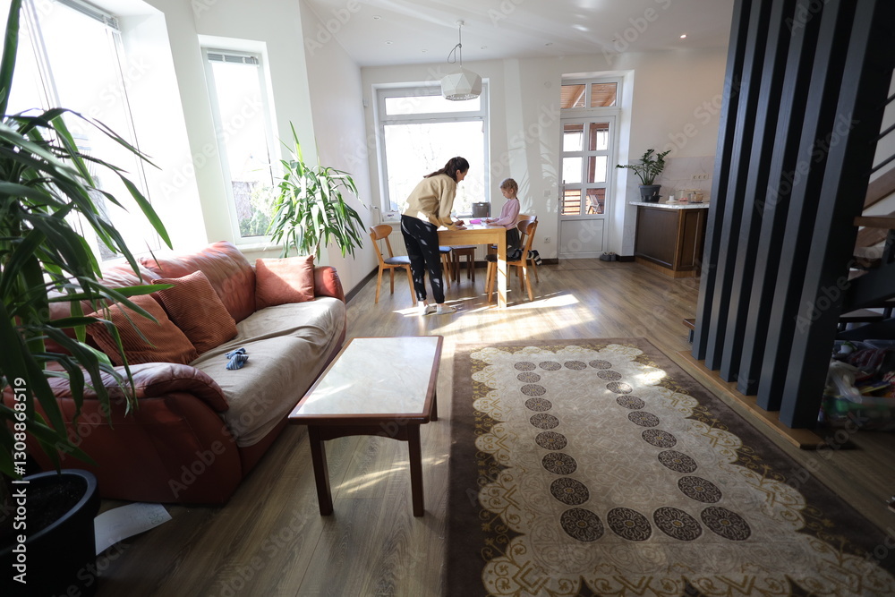 Fototapeta premium Mother and a daughter indoors spending time together