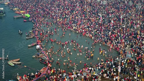 Aerial view of Huge crowd at Triveni Sangam in Prayagraj, India during Maha Kumbh. Kumbh Mela is the most important event, where millions of devotees, including Sadhu take a sacred holy dip in Ganga.