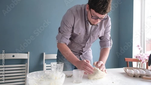 man kneading dough in the home kitchen