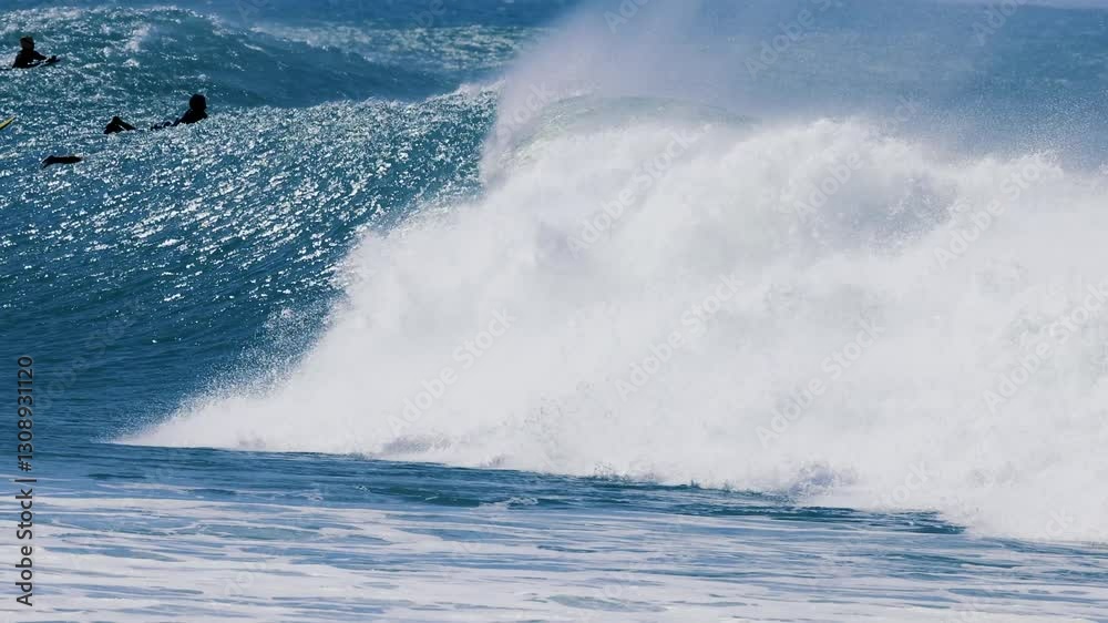 Surfers Riding Rough Pacific Ocean Waves