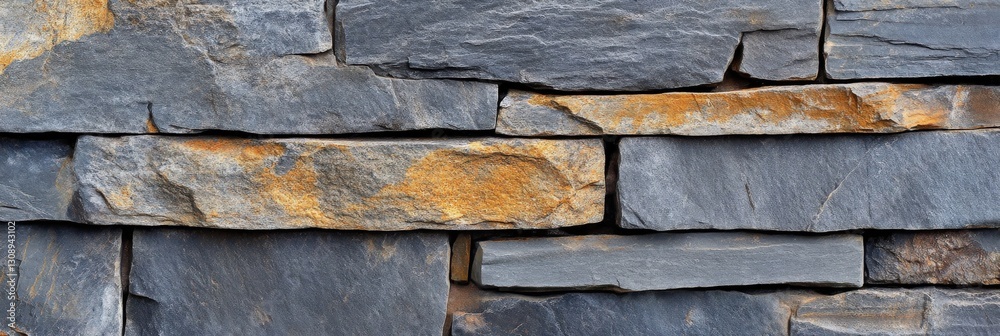 A closeup view of a stone wall with closely arranged bricks A closeup view of a stone wall with closely arranged bricks