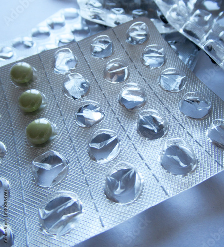 Empty pill blisters. A photo of medicines. Plates with leftover tablets