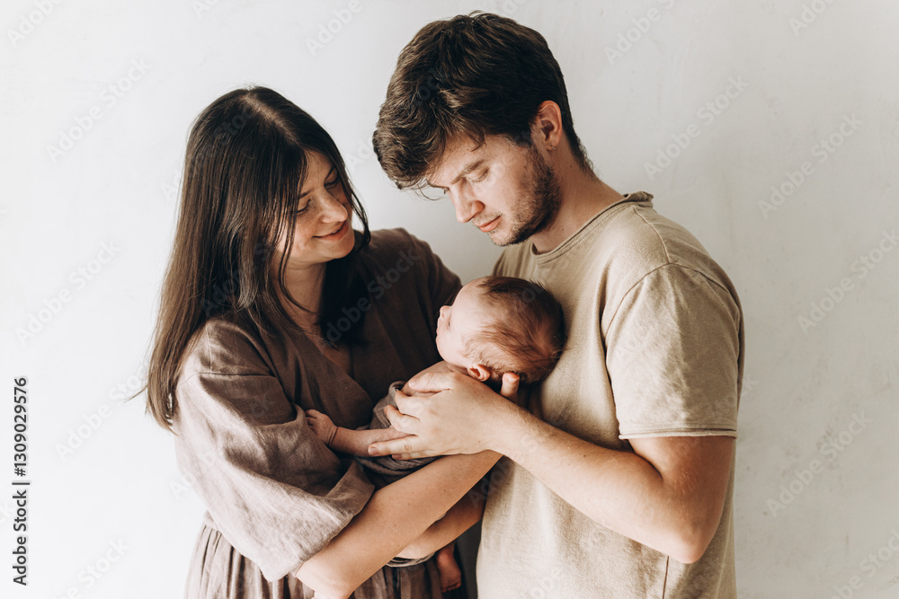 Happy mother and father hugging little baby son. Happy Mothers day and Happy Fathers day! Motherhood and parenthood. Adoption and fertility concept Happy mother and father hugging little baby son. Happy Mothers day and Happy Fathers day! Motherhood and parenthood. Adoption and fertility concept