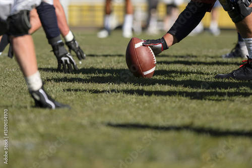 Football Players Lining Up on Field Ready for the Snap During Game