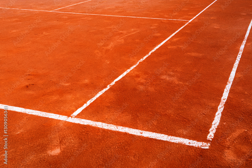 Fototapeta premium Tennis backround - Clay Tennis Court Surface with Marked White Lines on a Sunny Day