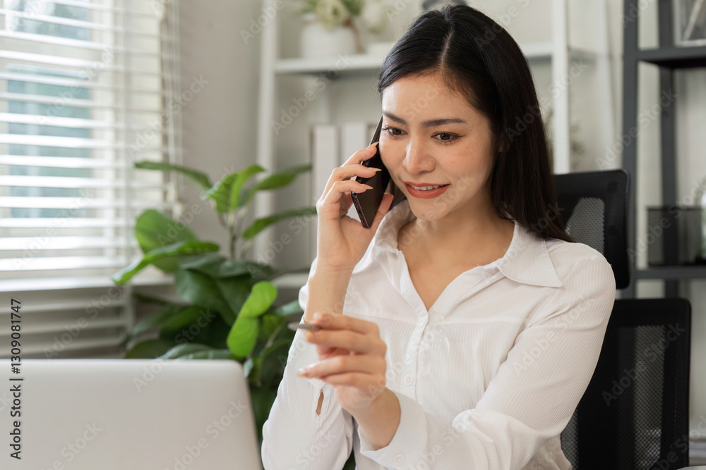 Engaging in financial discussions. A professional woman conversing on the phone while managing investment data.